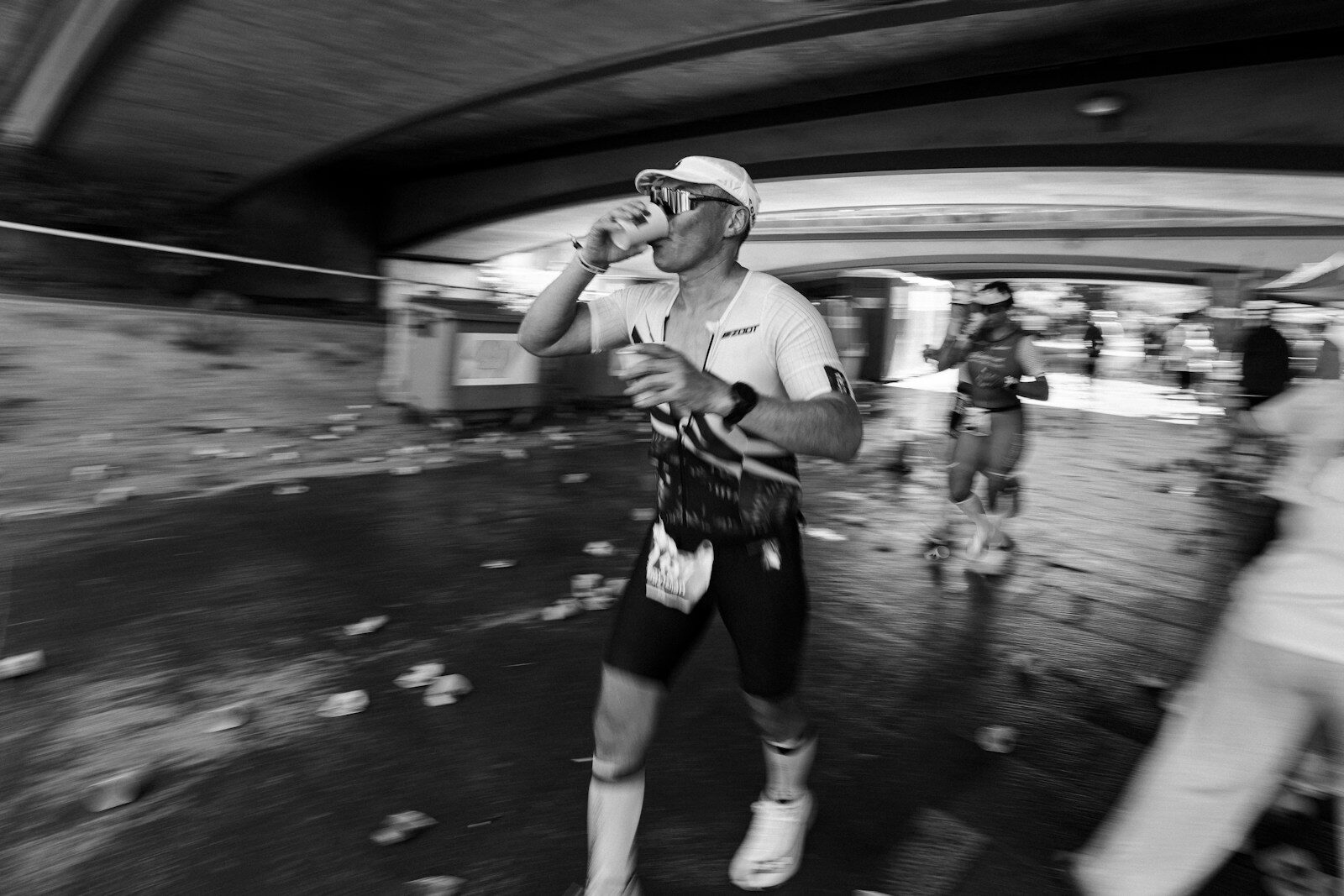 Runner drinks from cup during a race.
